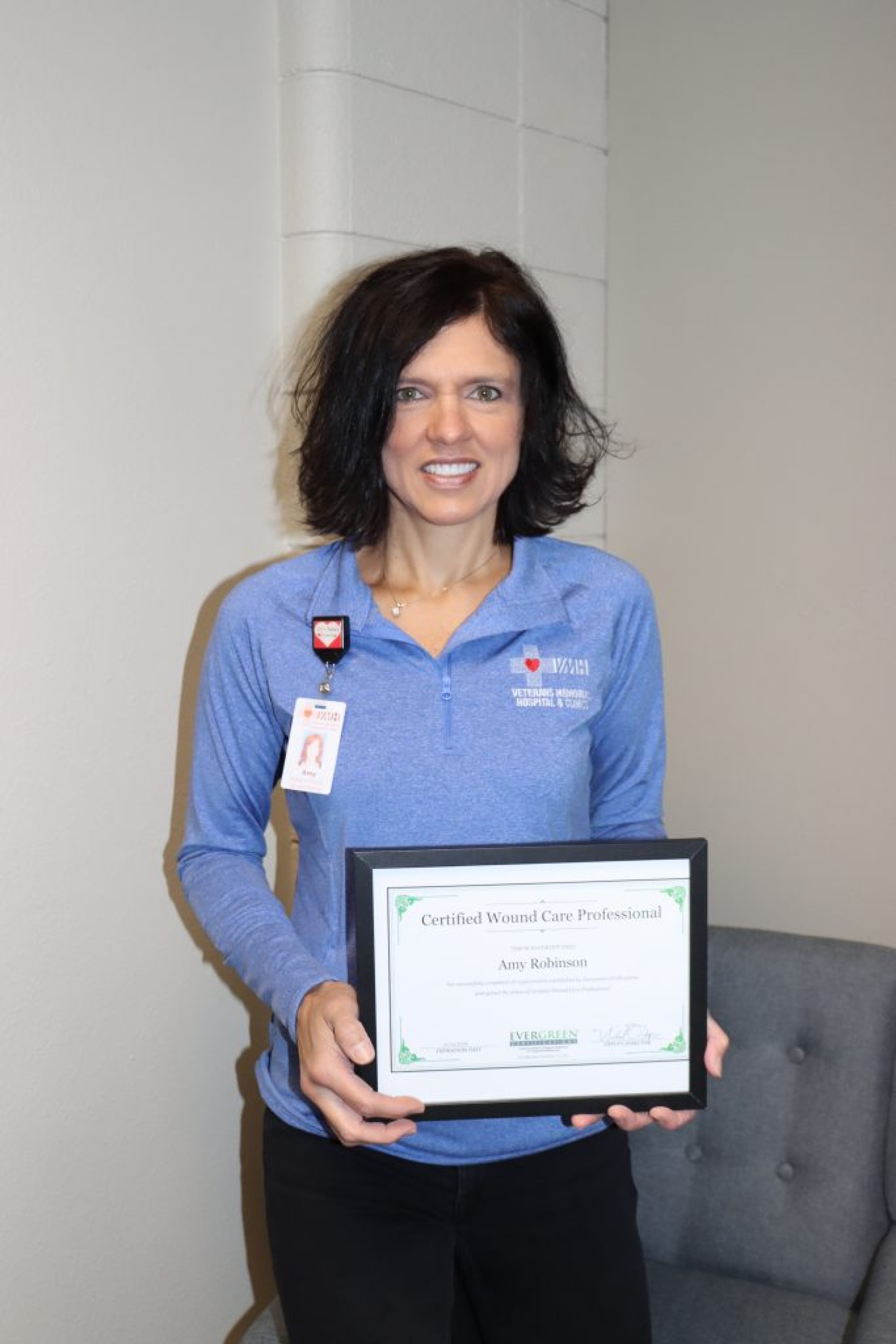 Amy Robinson with her certificate for Wound Care Professional.